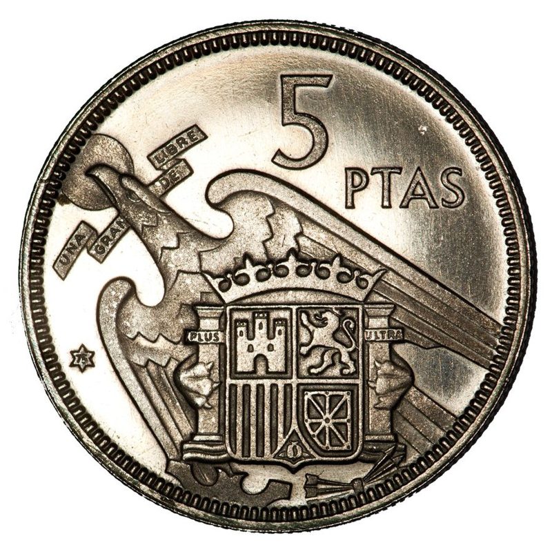 Escudo de España con el águila de San Juan, yugo y flechas, rodeado de leyendas y estrella de seis puntas con el 75.